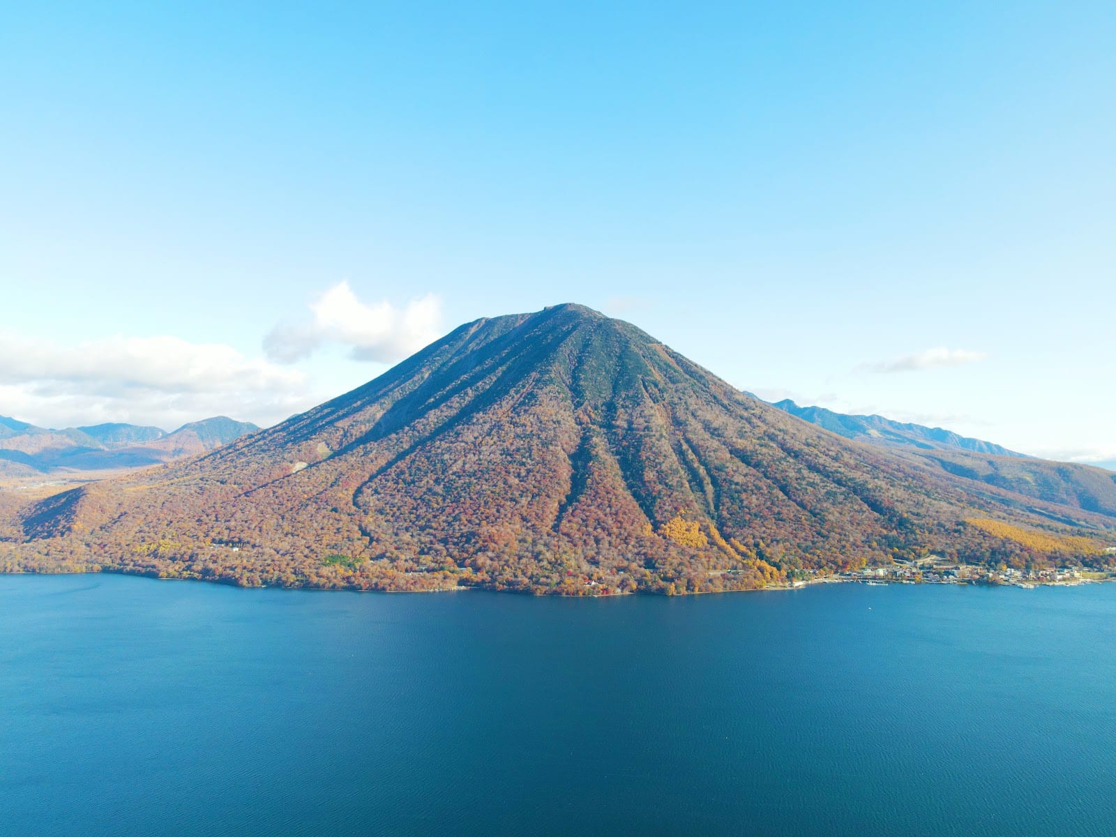 Serene blue Lake Chuzenji ringed by green mountains above Nikko.