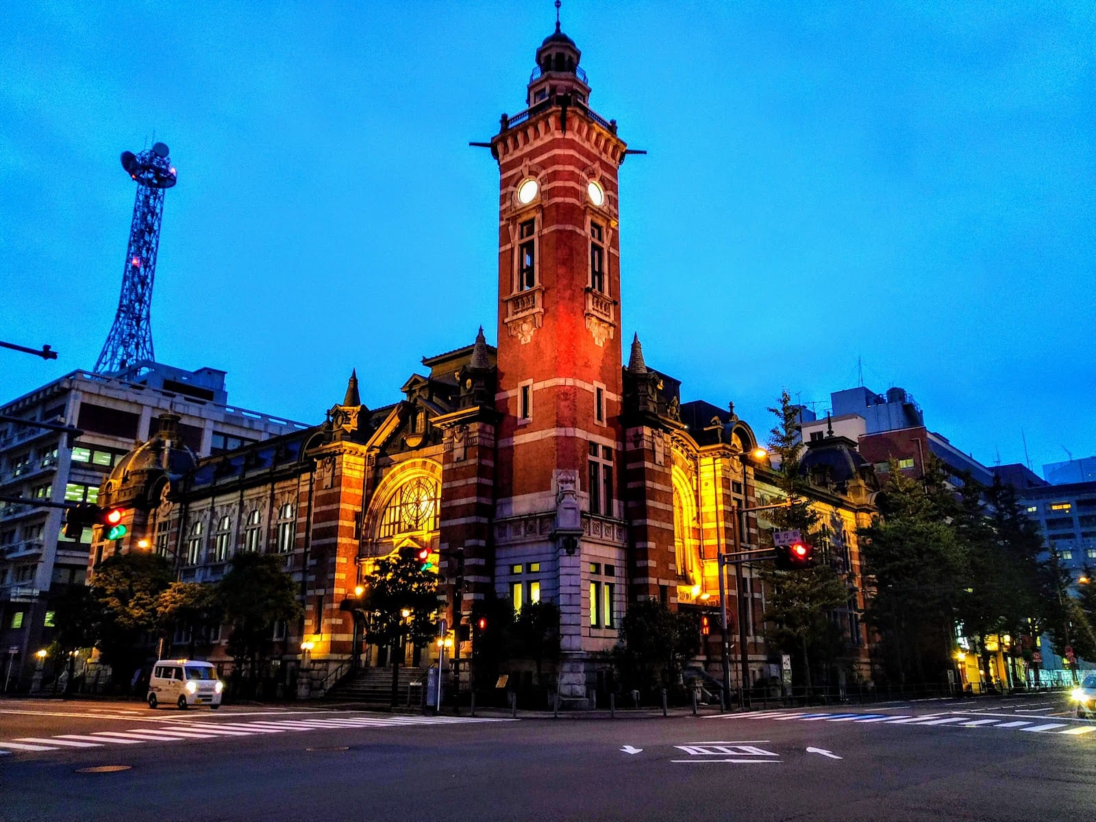 The red-brick clock tower of the Yokohama Port Opening Memorial Hall lit at night.