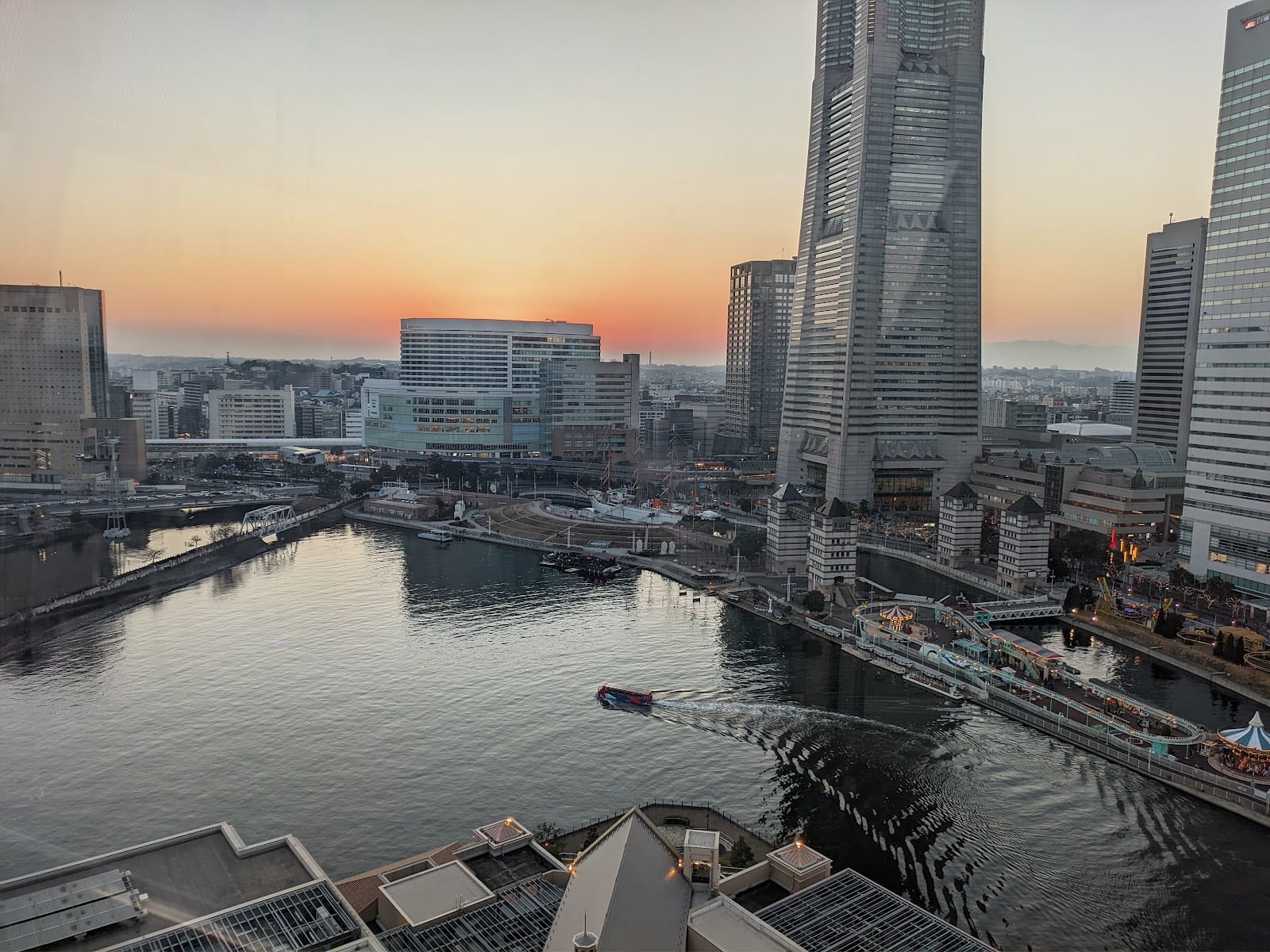 The Minato Mirai harbor and skyline at dusk seen from above.