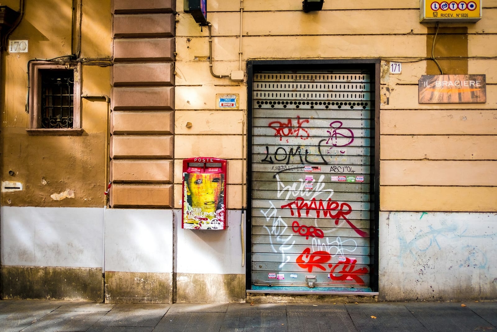 A graffiti-covered shutter on a street in the San Lorenzo quarter.