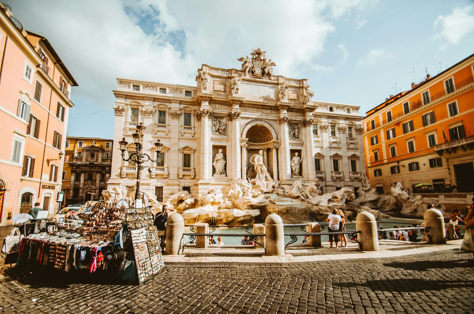 The Trevi Fountain in Rome glowing in afternoon sun, free to admire from the piazza.
