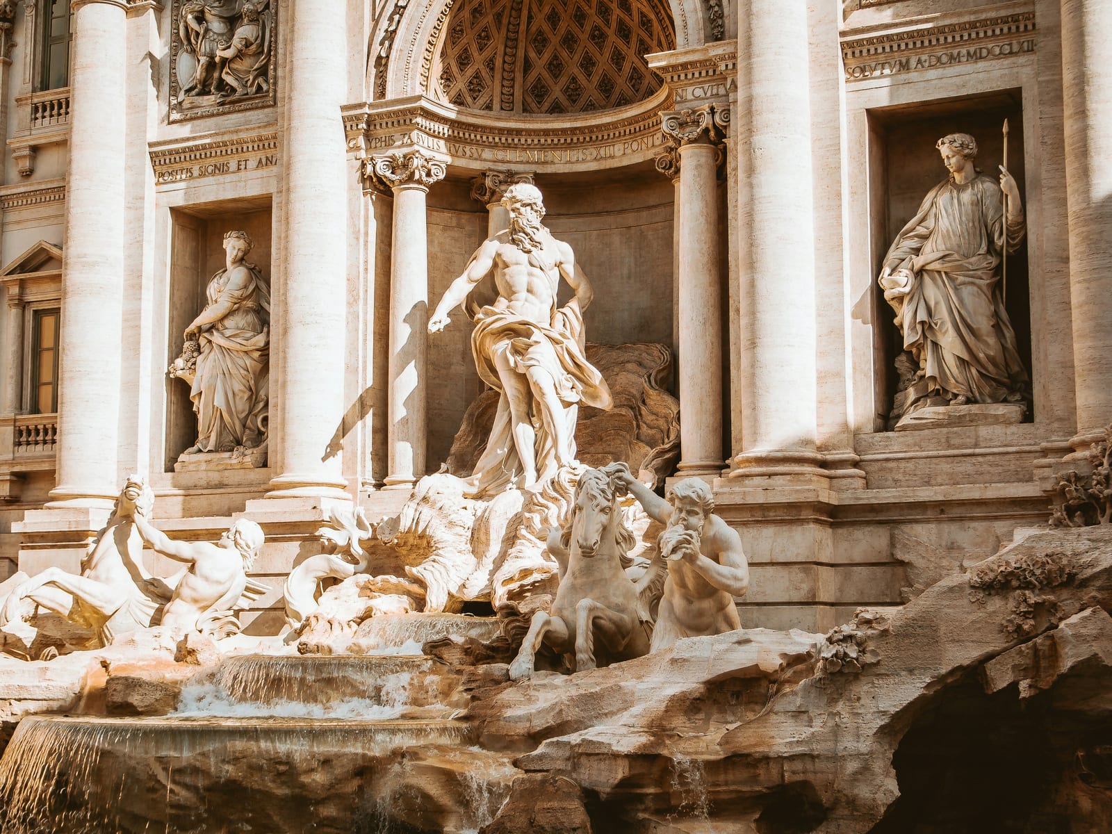 A marble equestrian sculpture group in a Roman park.