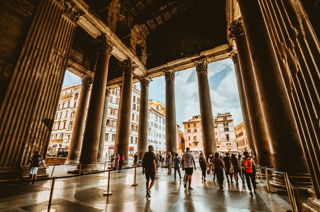 The columned portico of the Pantheon above the fountain in Piazza della Rotonda.