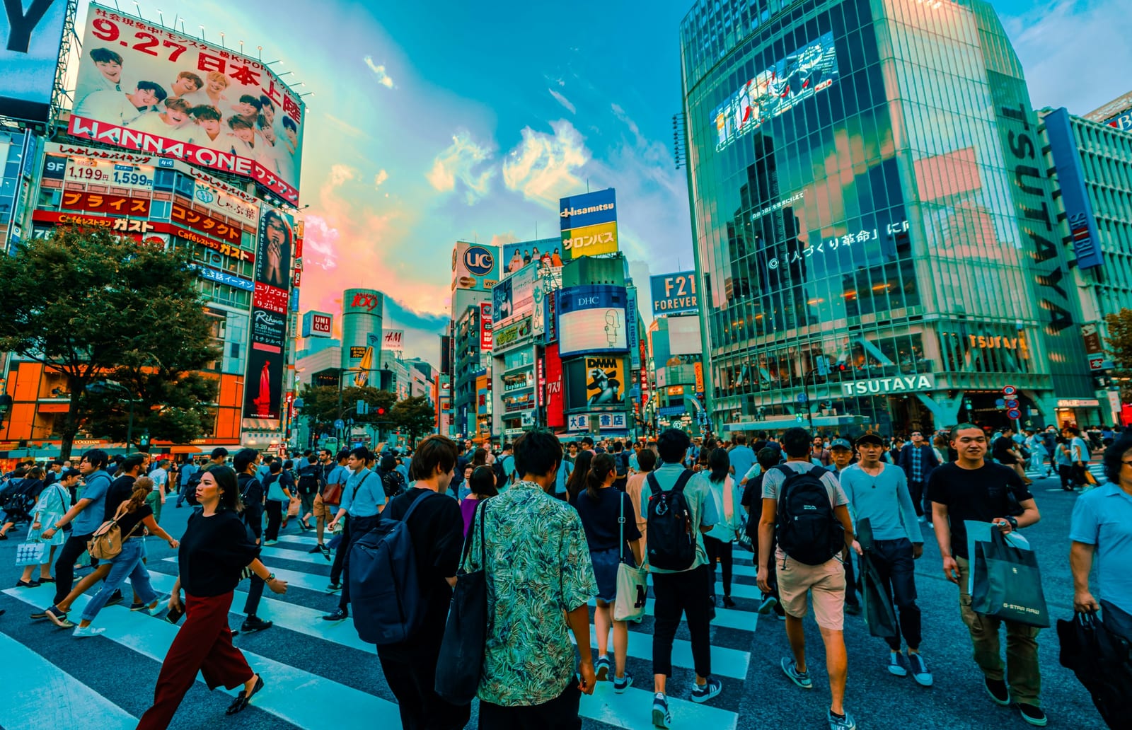 Crowds crossing the Shibuya scramble intersection at dusk.