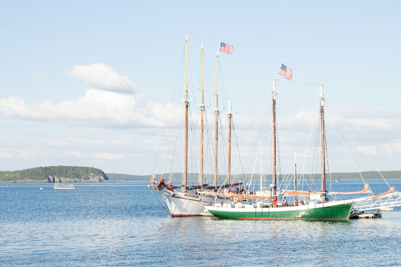 A replica colonial ship docked at a New England harbor.