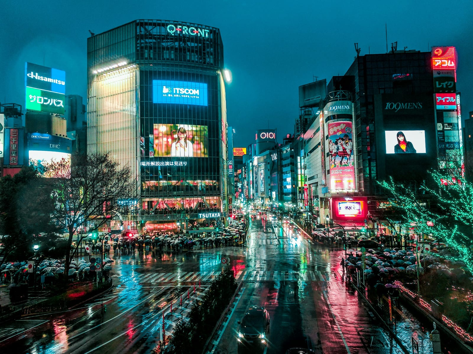 Shibuya Crossing lit up at night from above