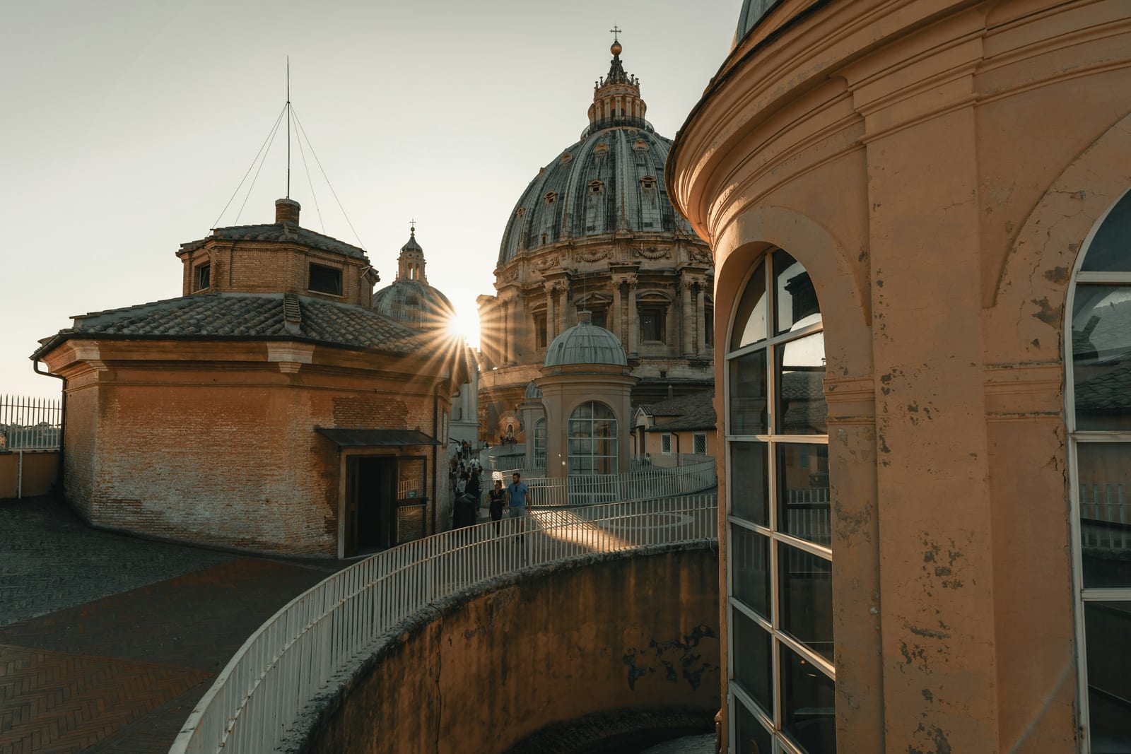 The dome of St Peter's Basilica catching golden light above the Vatican rooftops.