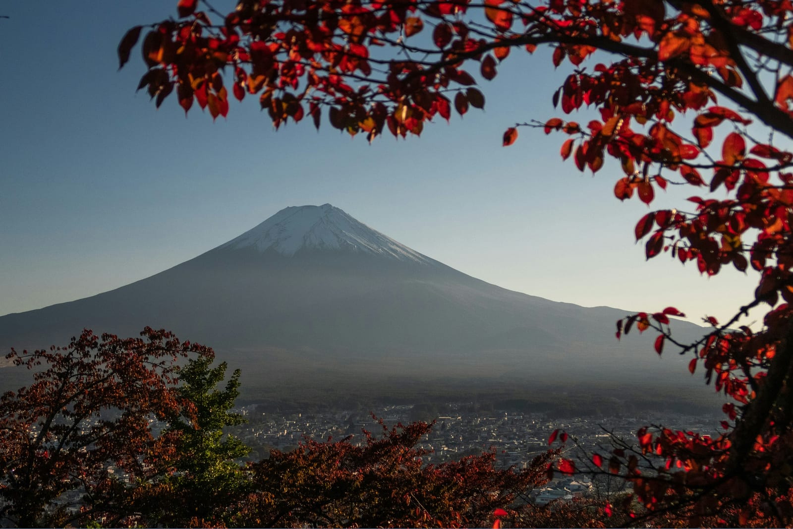 Snow-capped Mt. Fuji seen across the ridges from a Tokyo mountain trail.