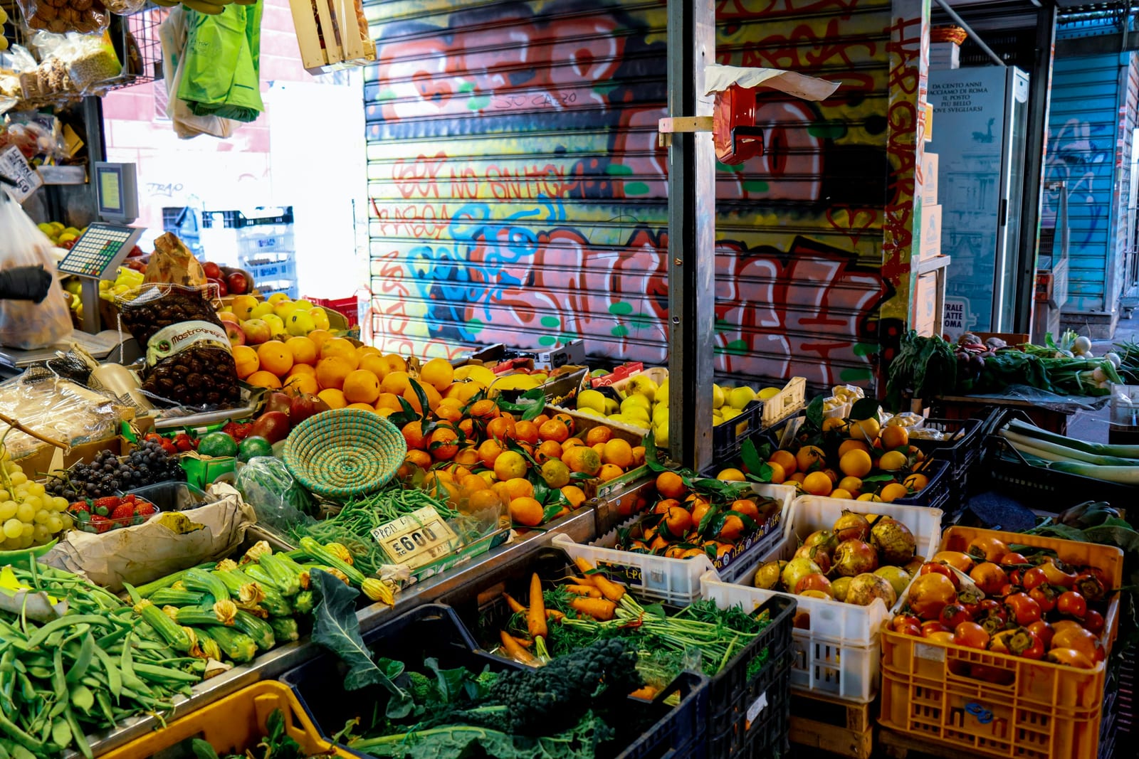 A colorful fruit and vegetable stall inside the Nuovo Mercato Esquilino.