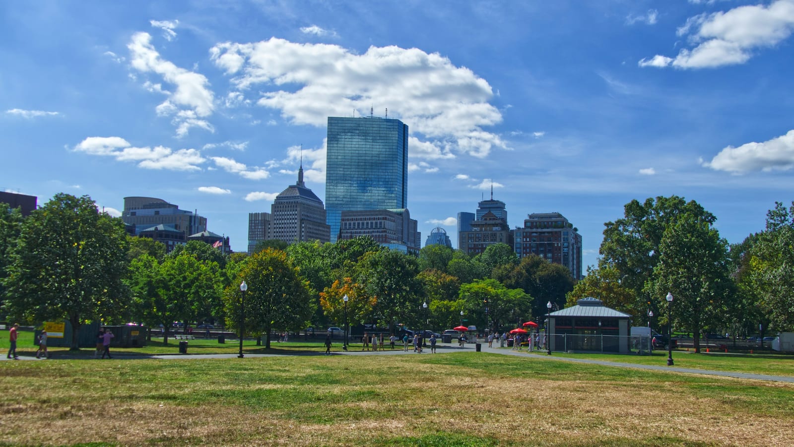Snow-covered Boston Common with the State House dome in the background on a clear winter day.