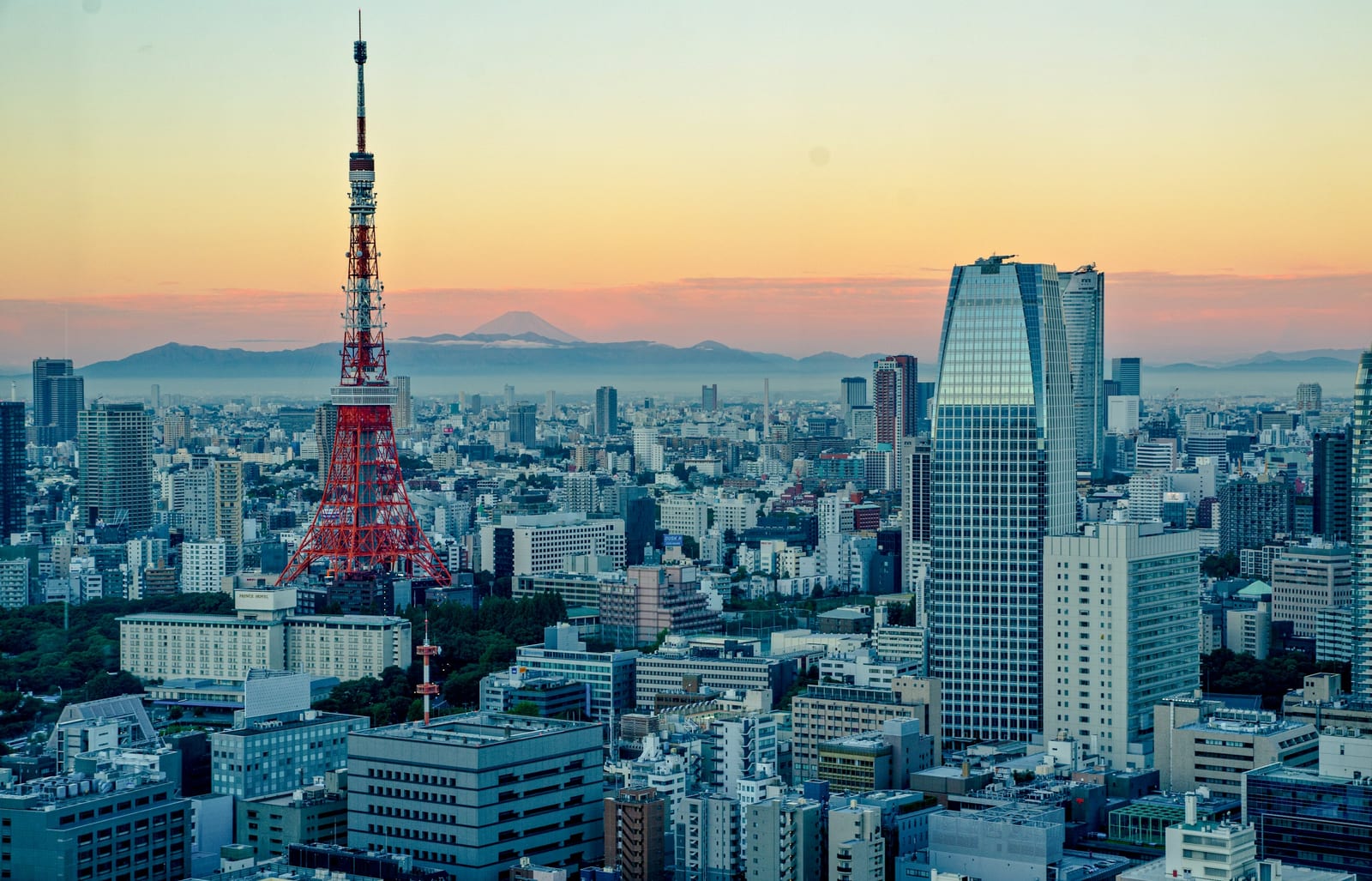 Tokyo Tower lit at dusk above the Roppongi skyline.
