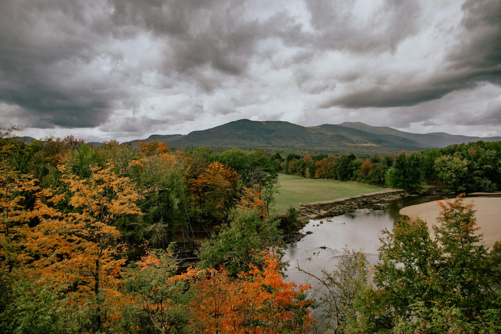 A New England valley filled with autumn color seen from a scenic overlook.