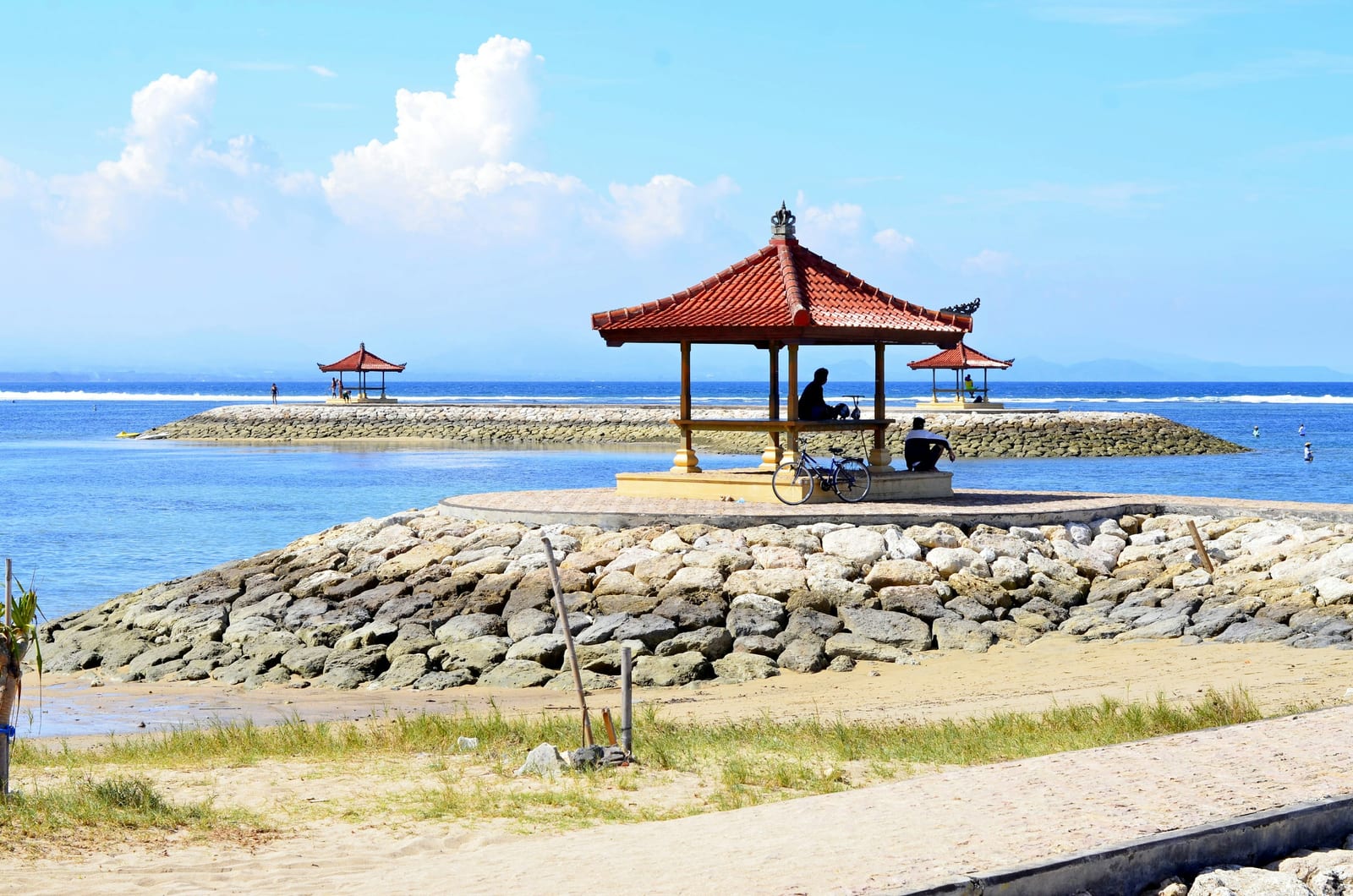 Red and brown wooden beach cottage on beach shore during daytime