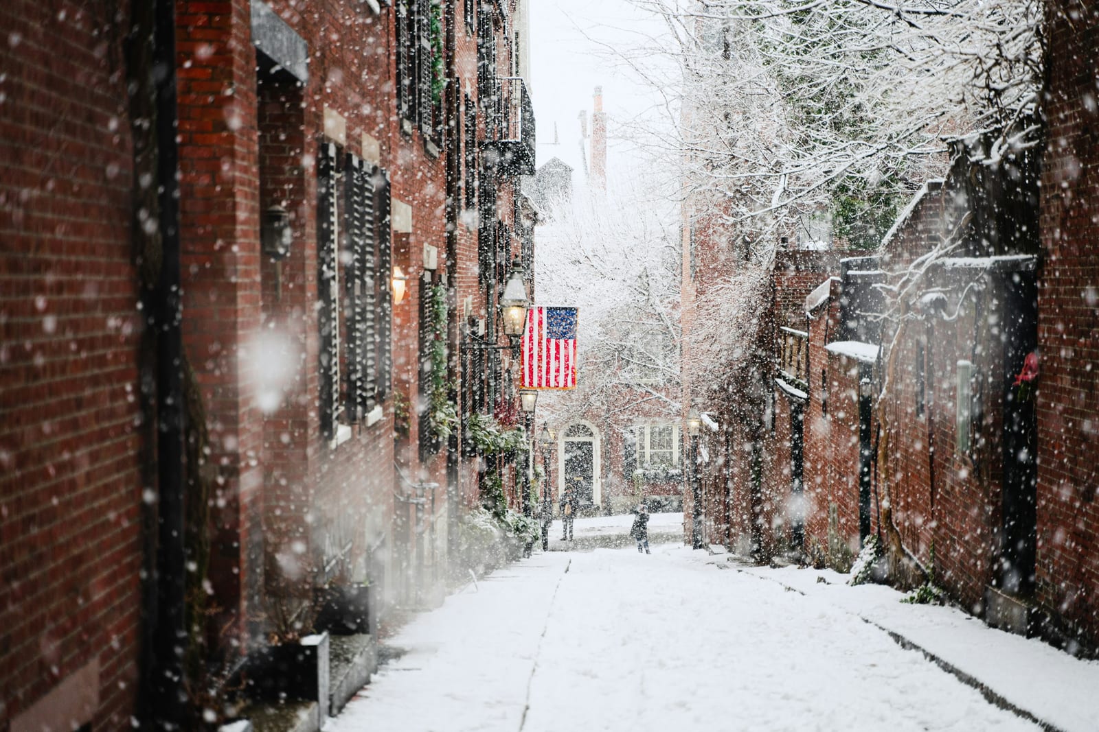 Acorn Street on Beacon Hill, cobblestones and brick row houses with American flags