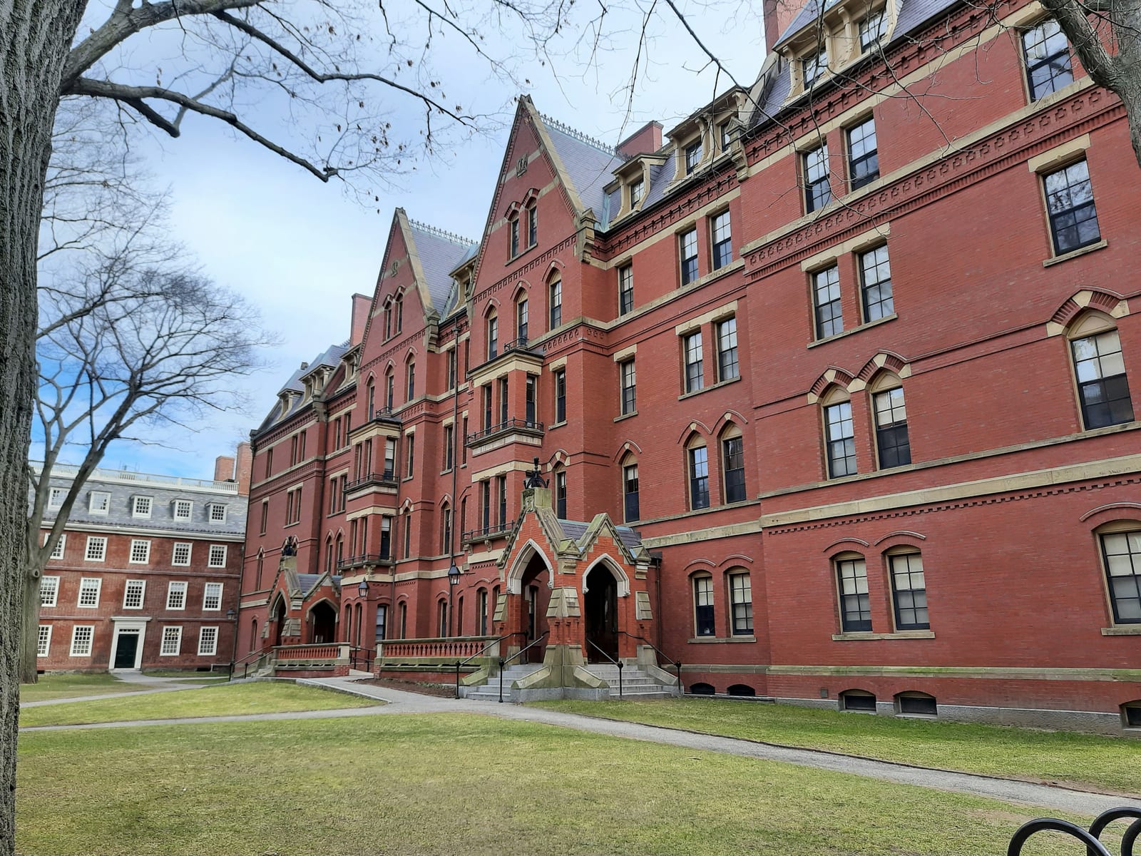 Harvard Yard in autumn, red brick buildings and fallen leaves