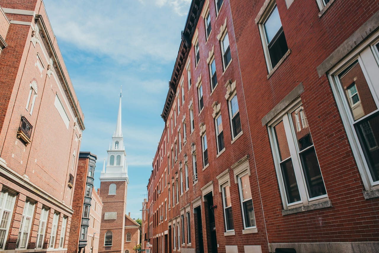 The white steeple of the Old North Church rises above the brick buildings of Boston's North End.