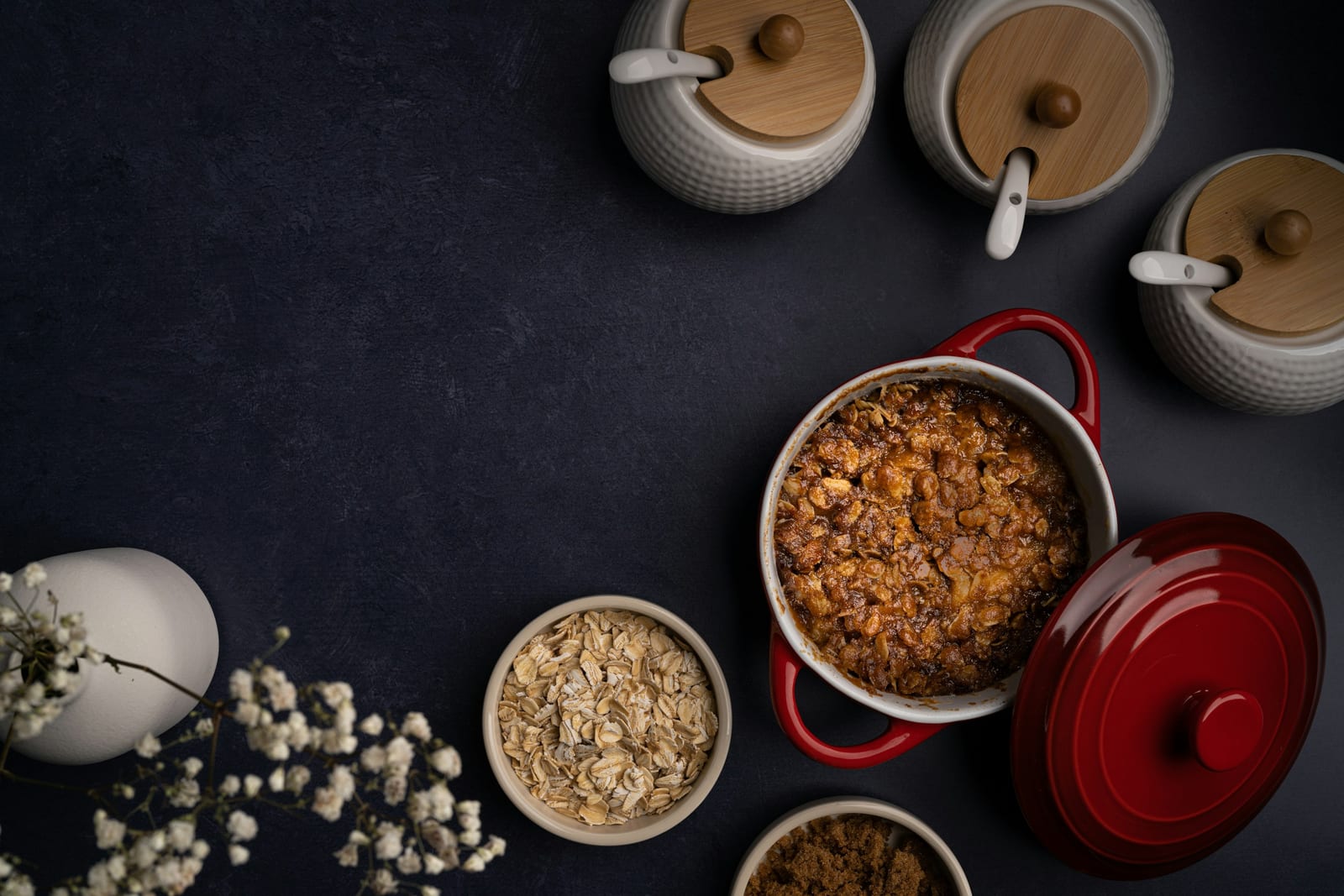 A cast-iron pot of baked beans in a thick, dark molasses sauce.