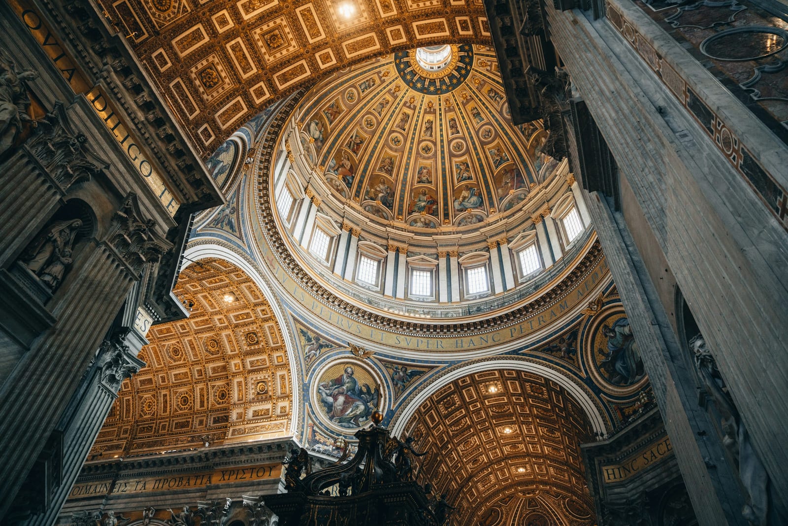 An ornate domed church interior with arched windows in Rome.