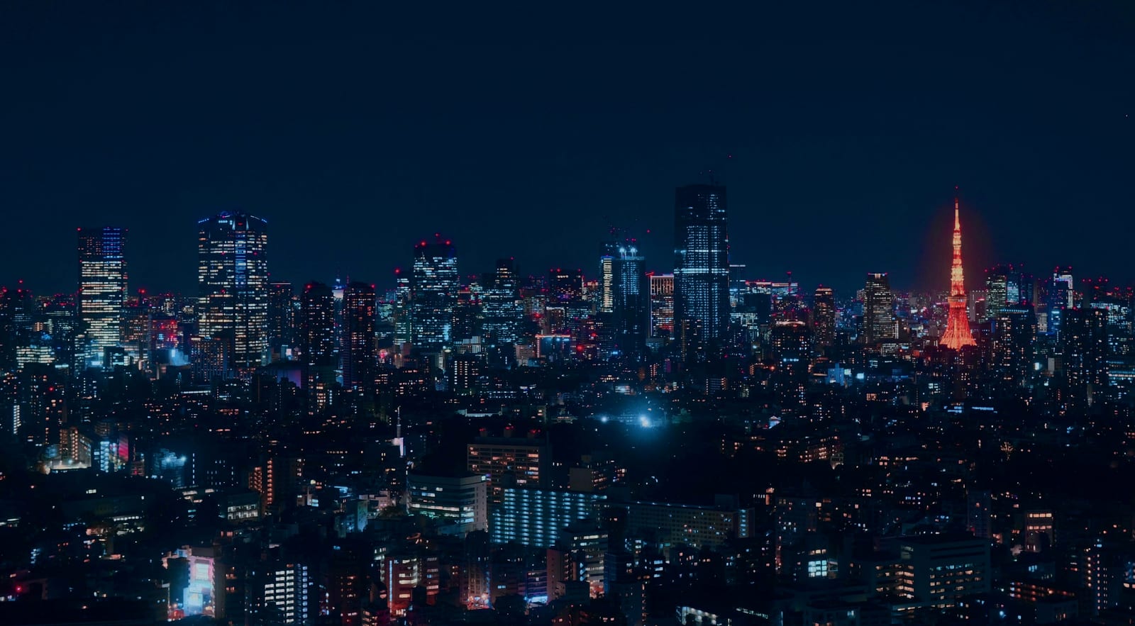 Central Tokyo's skyline lit up at night.