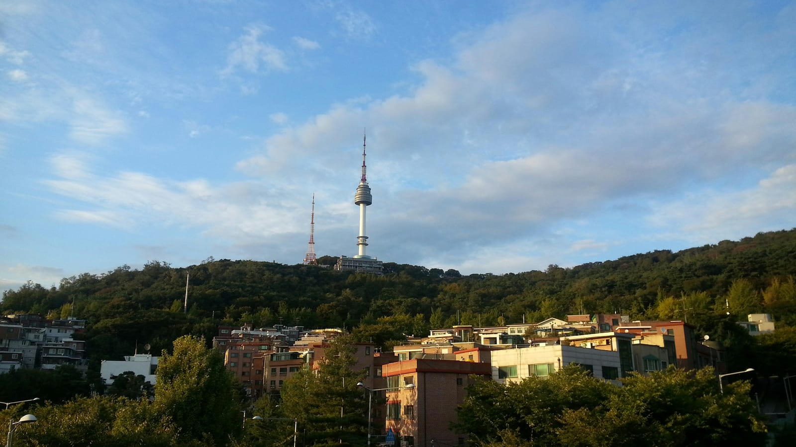 A view of a Seoul neighborhood with a tower in the background