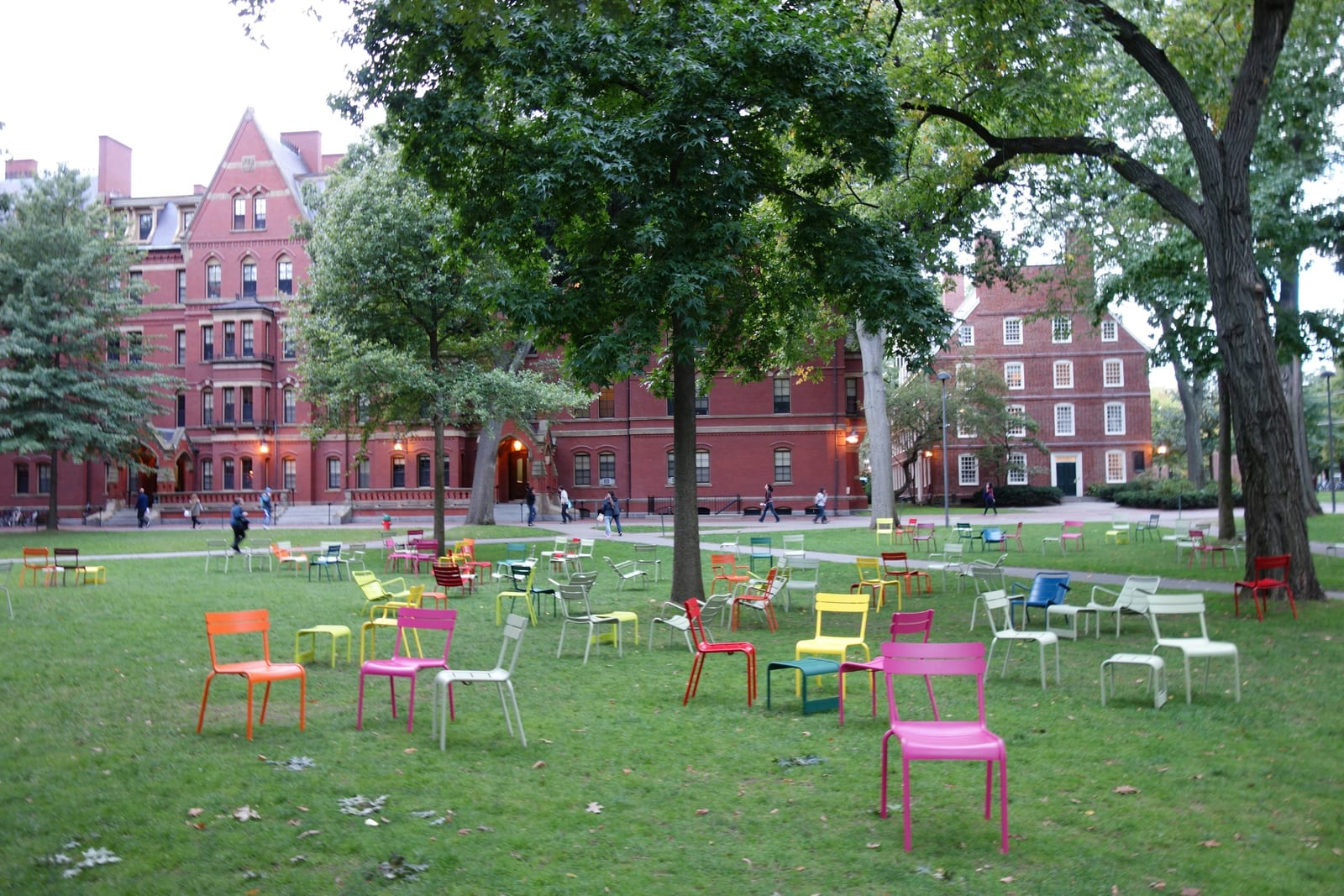 Harvard University campus with red brick buildings and green lawns.