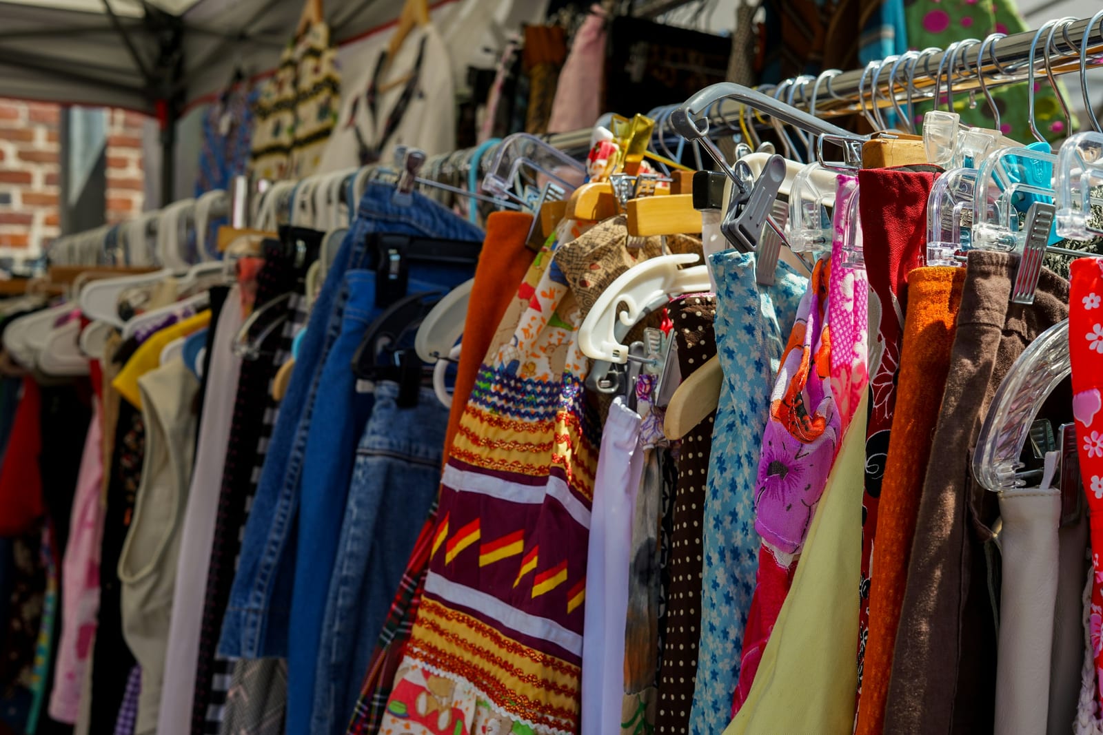 Racks of vintage and vintage-inspired clothing at a weekend design market.