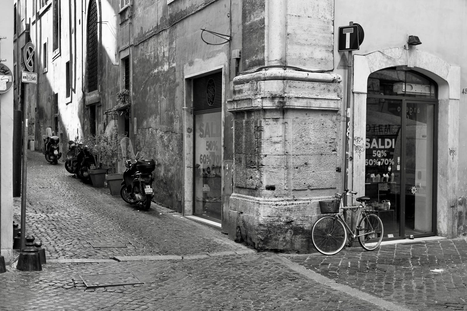 Scooters parked along a narrow Roman backstreet in Monti.