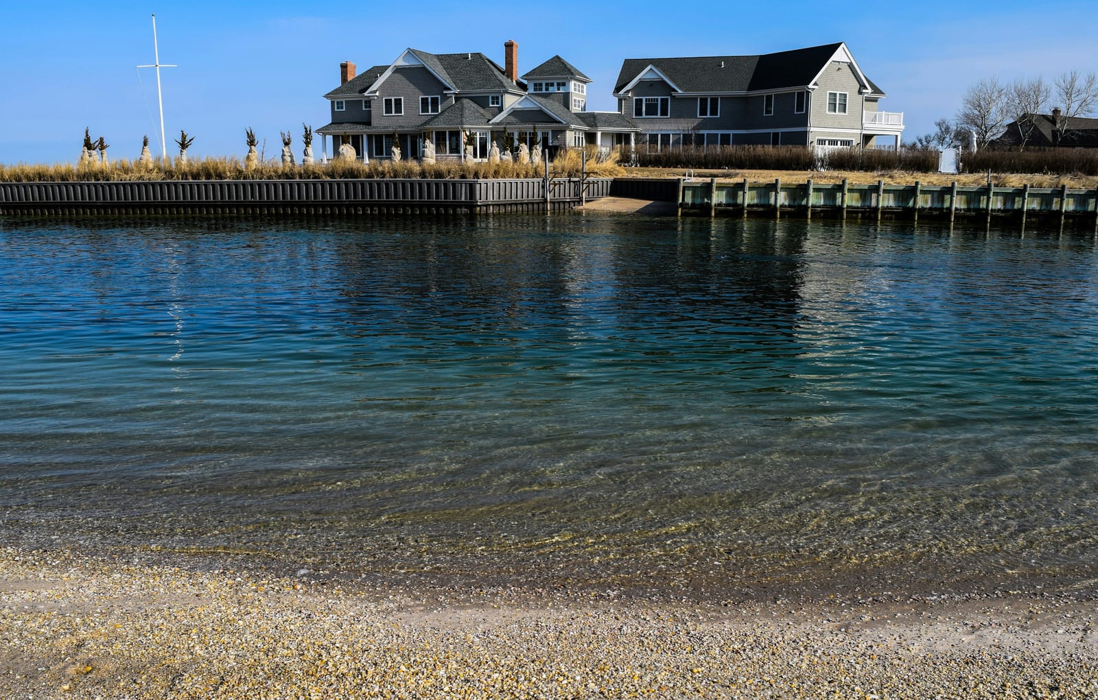 a body of water with houses in the background