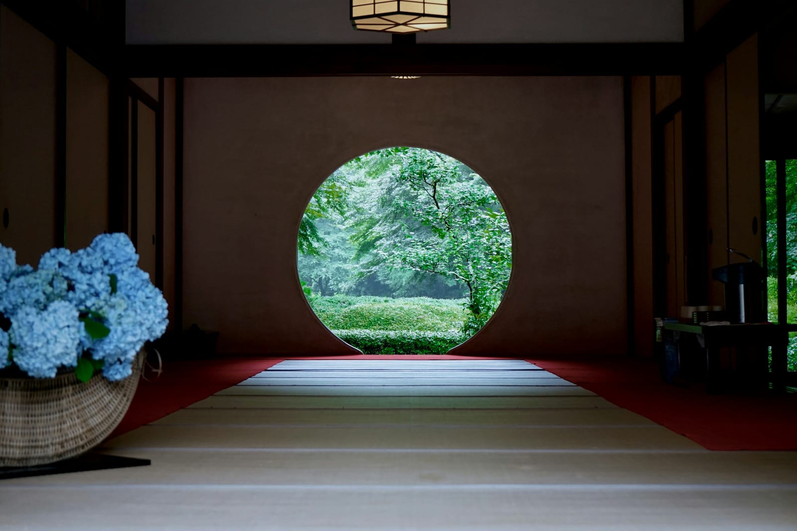 Meigetsu-in's round 'window of enlightenment' framing a green garden in Kita-Kamakura.