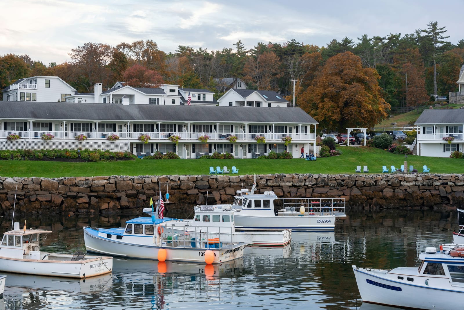 A small New England fishing harbor with colorful boats and lobster traps.
