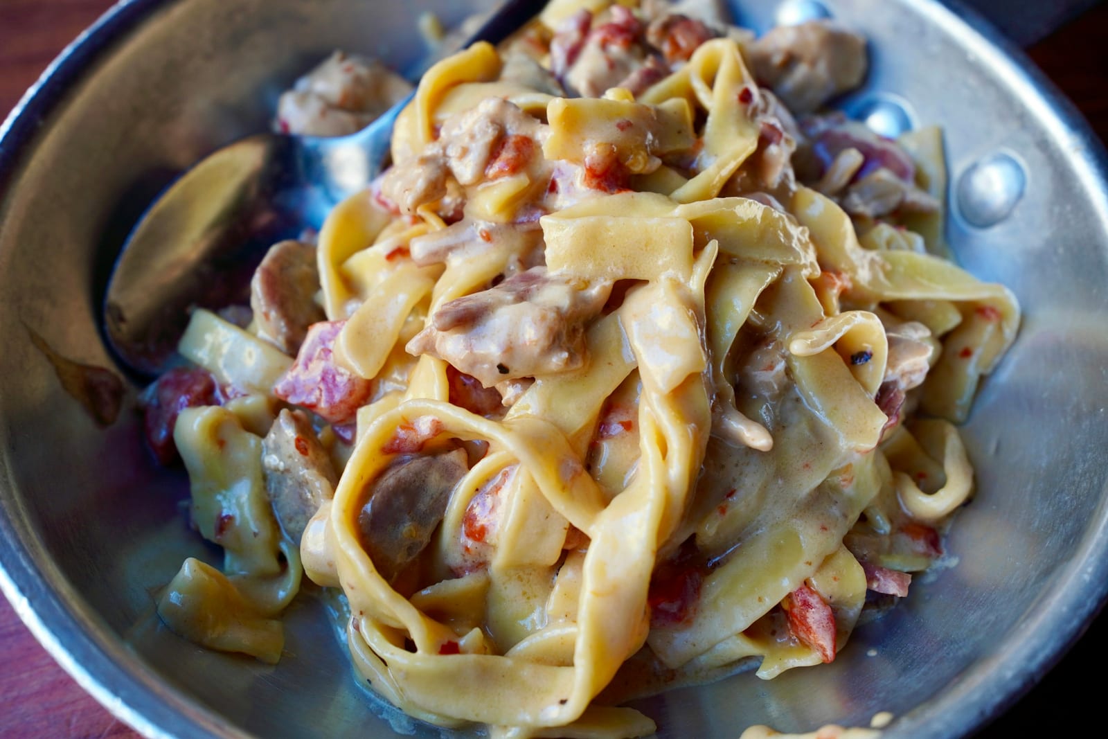 A plate of pasta alla gricia with crisp guanciale and pecorino.