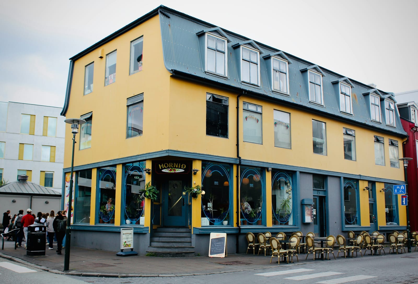 A yellow and blue restaurant building on a Reykjavik street.