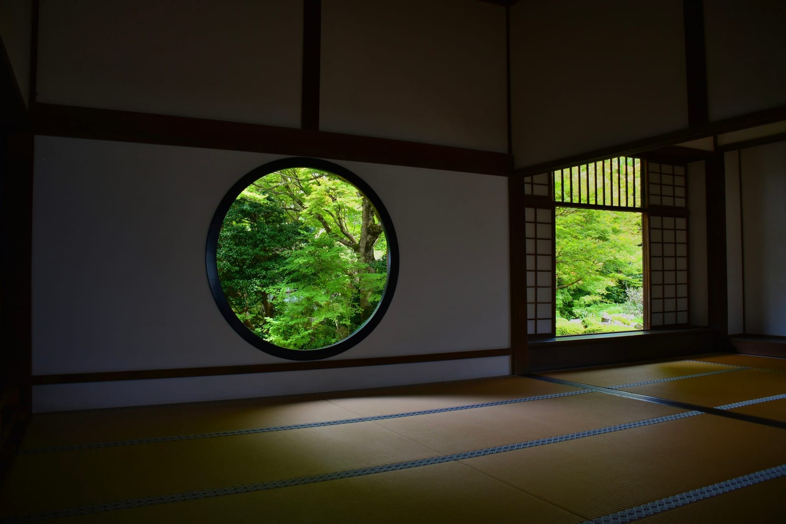 Meigetsu-in's round 'window of enlightenment' framing a green garden in Kita-Kamakura.