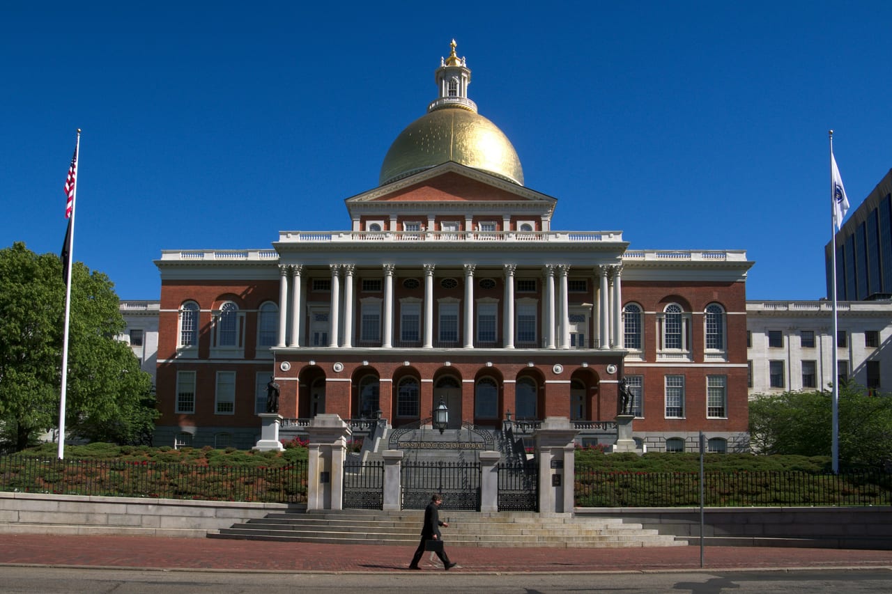 The gold dome of the Massachusetts State House rises above Beacon Hill's brick townhouses.