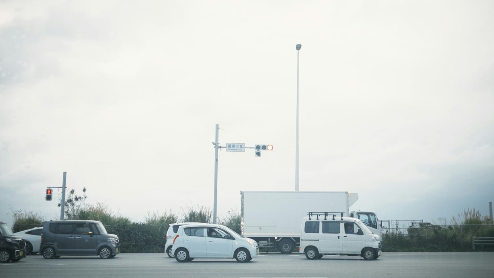 Cars and a truck at a traffic light