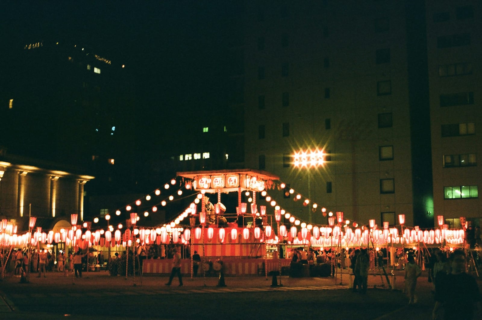 Paper lanterns lighting an outdoor summer festival at night in Tokyo.