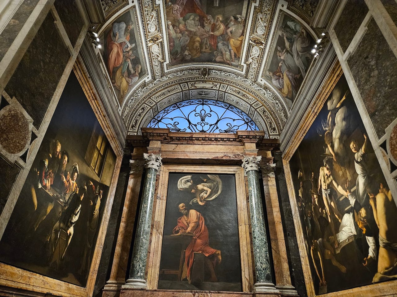 The Contarelli Chapel in San Luigi dei Francesi, its three Caravaggio canvases of the St Matthew cycle flanking the altarpiece of the angel.