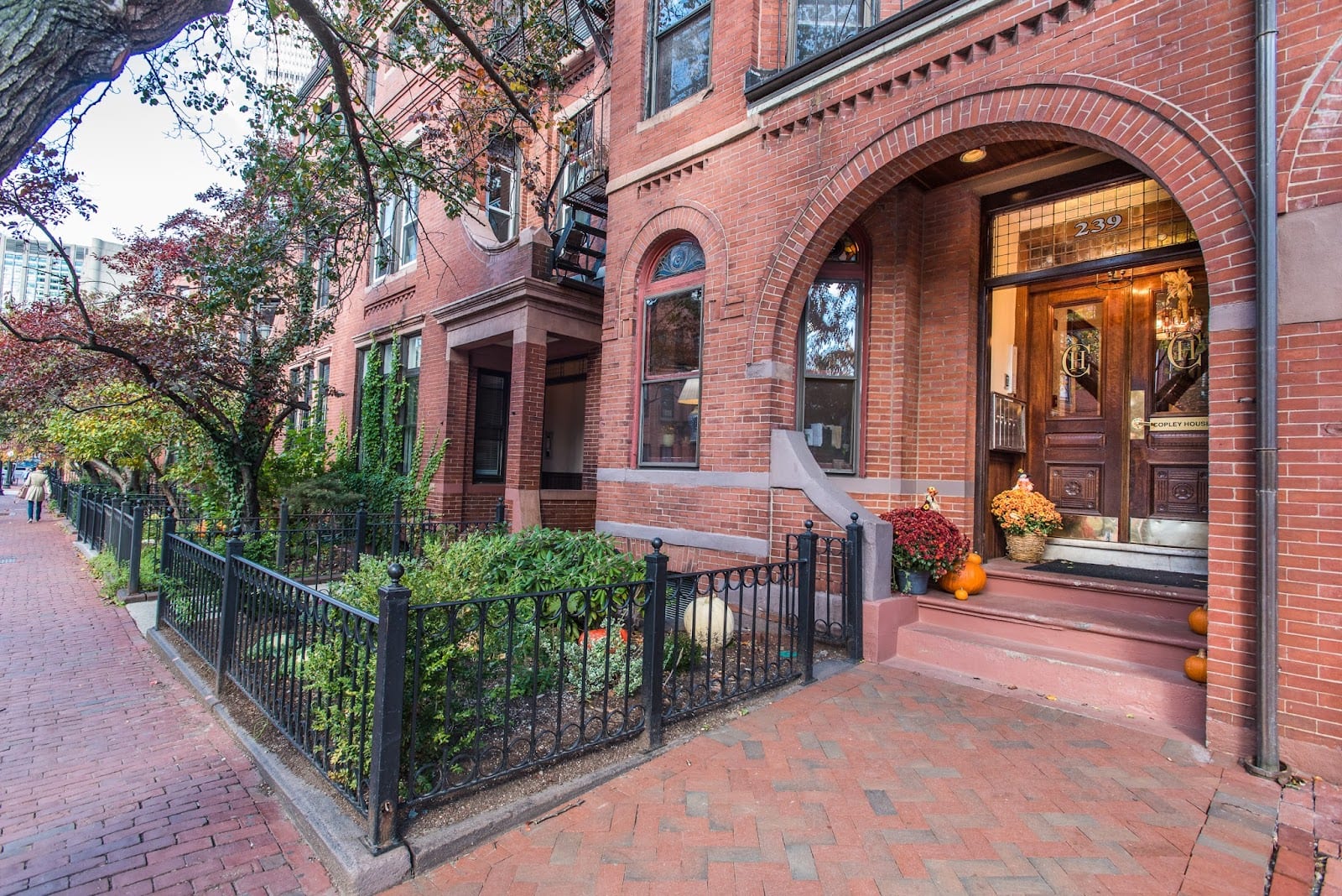 Brownstone row houses along a tree-lined Back Bay street